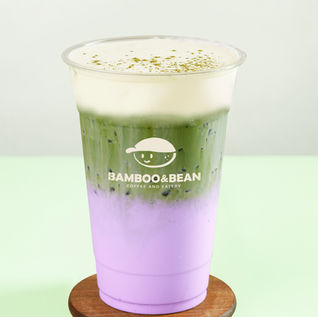 Iced matcha latte drink with layers; Bamboo and Bean logo. HOME. Refreshing beverage.