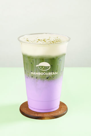 Iced matcha latte drink with layers; Bamboo and Bean logo. HOME. Refreshing beverage.