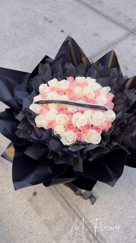 Pink and white rose bouquet in black wrapping