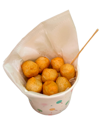 Golden fried fish balls in paper cup with wooden skewer.