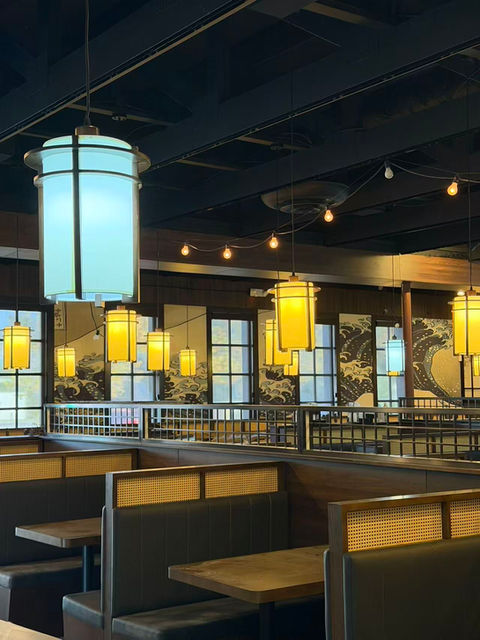 Interior view of a Japanese restaurant with decorative hanging lights and tables.
