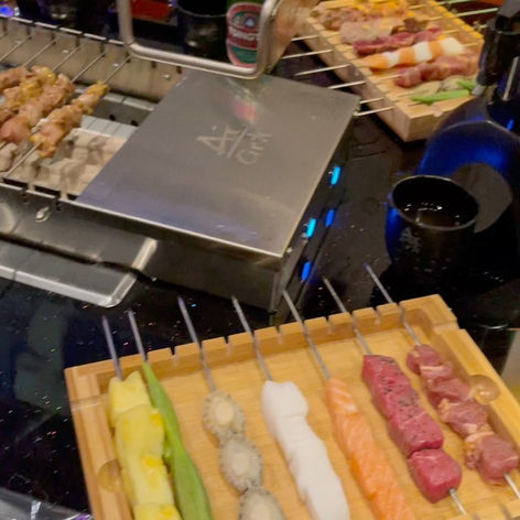 Various food skewers, AJS grill, meat, seafood, and vegetables.