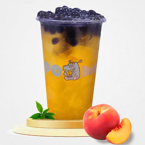 Refreshing BOOBA peach bubble tea with dark boba and fresh peaches.