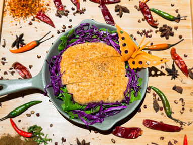 Spicy breaded dish with purple cabbage and butterfly