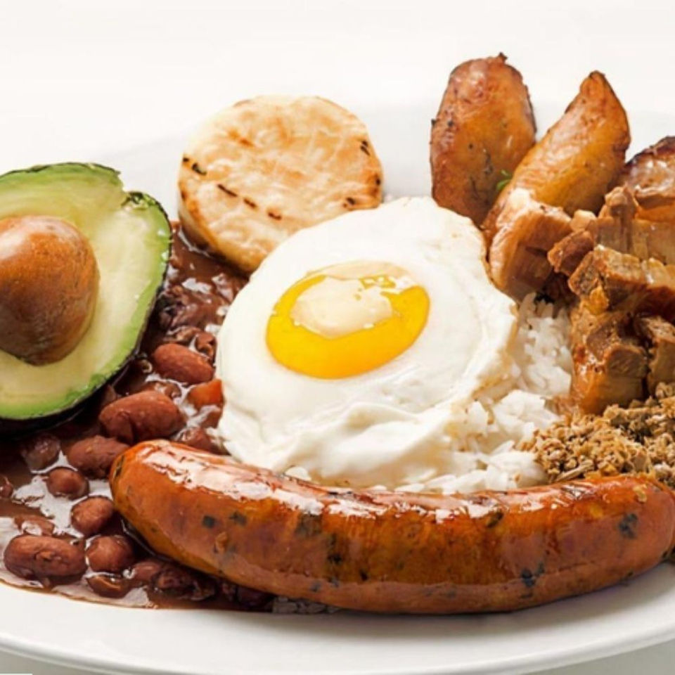Colombian Bandeja Paisa with chorizo, fried egg, beans, rice, avocado.