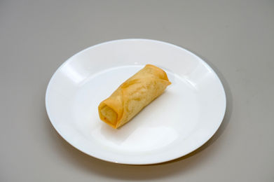 Egg roll on a white plate
