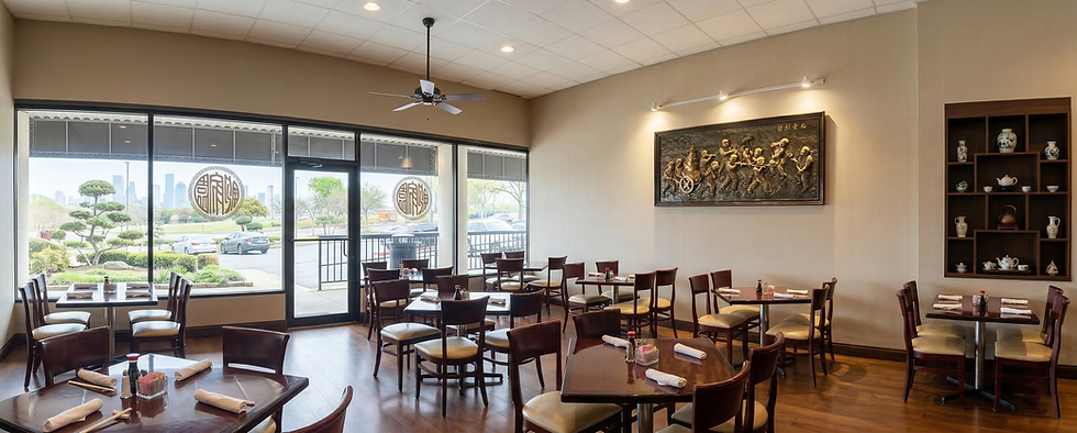 Restaurant interior with tables, chairs, and large windows