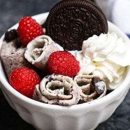 Rolled ice cream with raspberries and an Oreo cookie, delicious dessert.