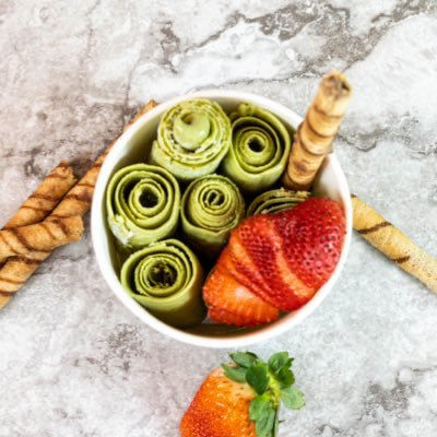 Green ice cream rolls with strawberry slices and wafer sticks Broadway Food Court