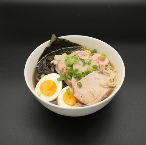 Bowl of ramen with pork, eggs, green onion, and narutomaki