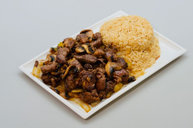 Plate of beef and mushroom stir-fry with fried rice