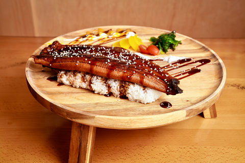 Grilled eel sushi on wooden plate with sauce and garnish, Yoi Sushi