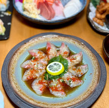 Delicious sushi dish with lemon and sauce, Yoi Sushi on the table.
