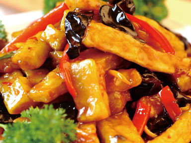 Delicious dish with fried vegetables and red peppers on a plate