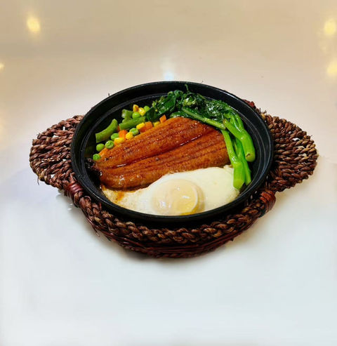 A plate with a meal including an egg, vegetables, and meat.