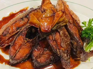 Delicious glazed fish dish with sauce on a white plate