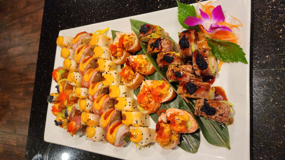 Sushi platter with colorful rolls, fresh ingredients, and artistic presentation.