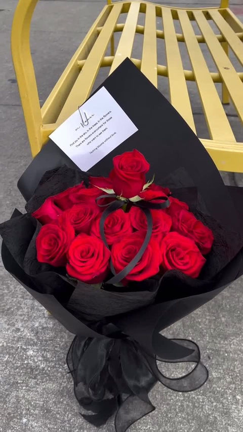 Red rose bouquet in black paper