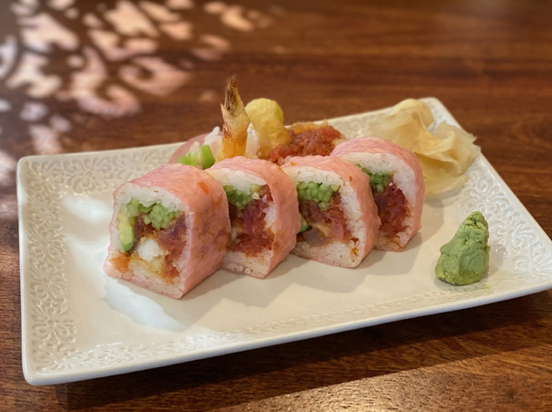 Pink sushi rolls with avocado, tuna, ginger, and wasabi