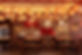 Restaurant interior with wooden tables, benches, red Chinese characters, and hanging lanterns.