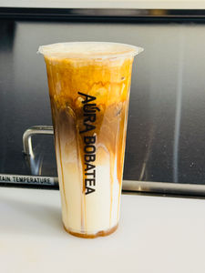 Iced Aura Bobatea drink with layers of milk in a clear plastic cup