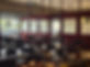 Restaurant dining area with empty tables and large windows