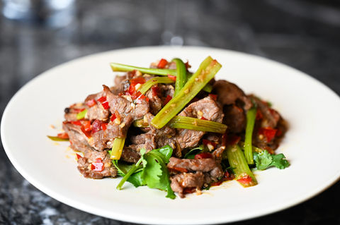 Spicy stir-fried beef with red peppers, green celery, and cilantro.