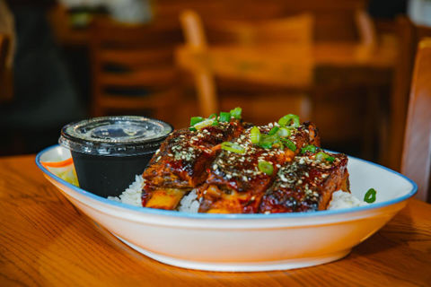 Delicious glazed ribs, rice, and sauce in a bowl at Nami Asian Noodle Bar