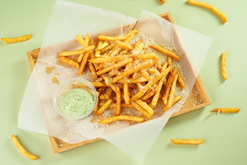 Golden french fries with cheese and dip on tray, HOME, light green background