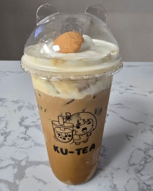 Iced coffee drink with whipped cream and KU-TEA label, tasty treat.