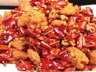 Close-up of fried chicken with red peppers, a delicious Asian cuisine.