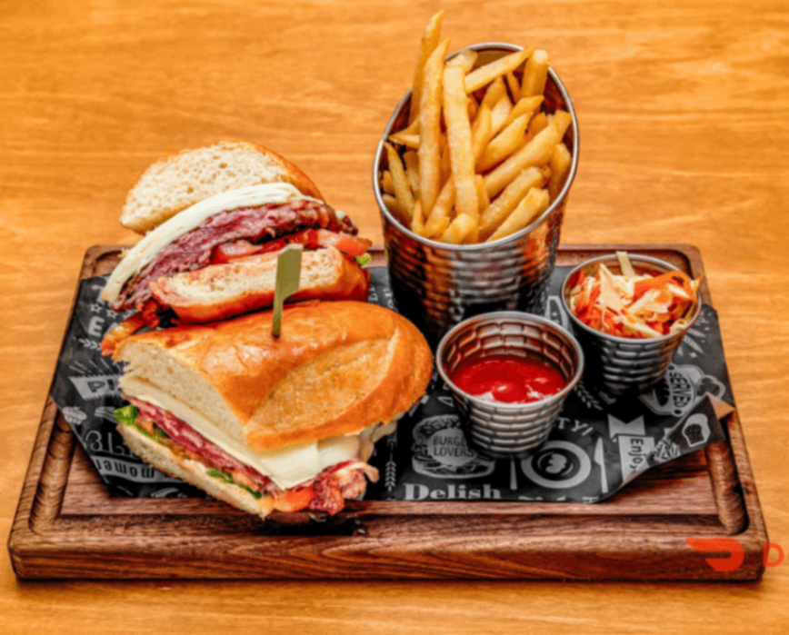 Large deli sandwich cut in half with fries, ketchup, coleslaw. Delish.