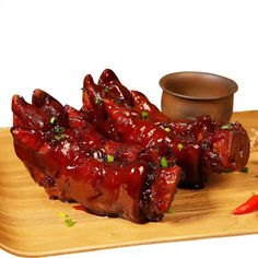 Braised Pig's Trotters and sauce on a wooden tray, with a small bowl. Yang Sao 杨嫂炸串