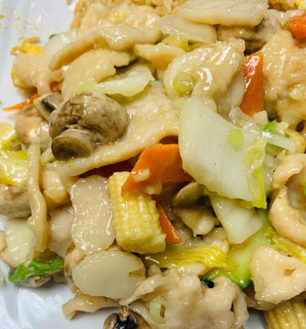 Close-up of a stir-fry dish with various vegetables and mushrooms.