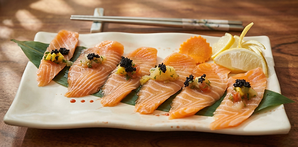 Salmon sashimi with caviar on a white plate