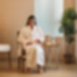 a person sitting in a spa wearing a robe with an iv connected to their arm.jpg