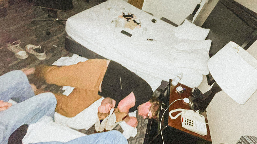 man waking up on hotel room floor after a night out clubbing