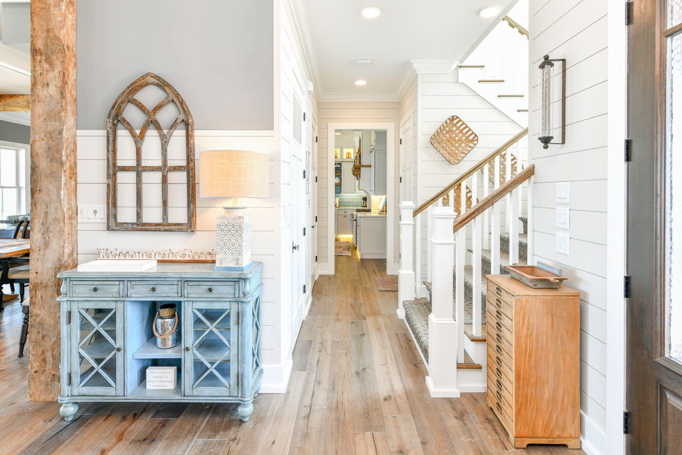 Inviting entrance with staircase and rustic furniture