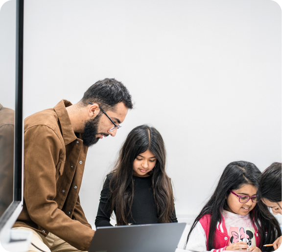 Teacher helping child studying at studyright.png