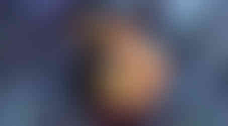 Romantic visual novel scene of a shirtless samurai passionately kissing a yellow-skinned oni with long black hair and horns. The oni wraps his arms around the samurai’s neck while they embrace in a hot spring setting, mist and glowing lights surrounding them. A dialogue box at the bottom simply displays the oni’s name, “Aku.”