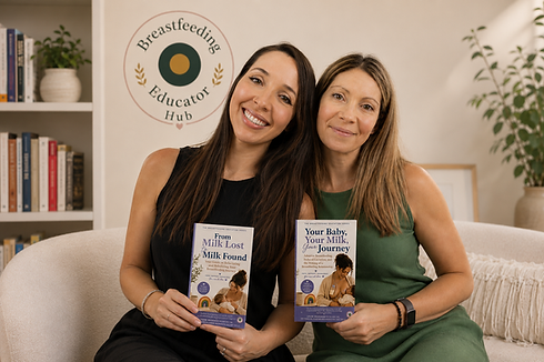 Two women sitting on a couch, each holding a book, engaged in conversation and sharing idea