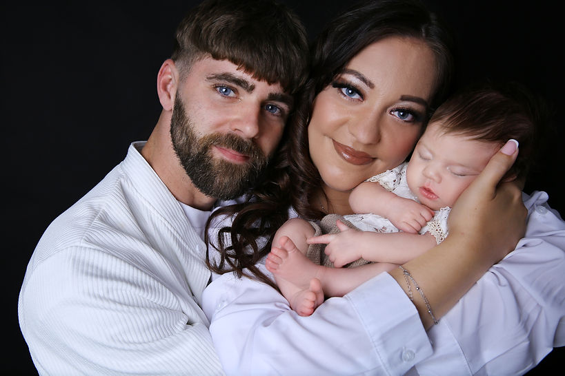 Proud mother and father holding their bran new baby girl