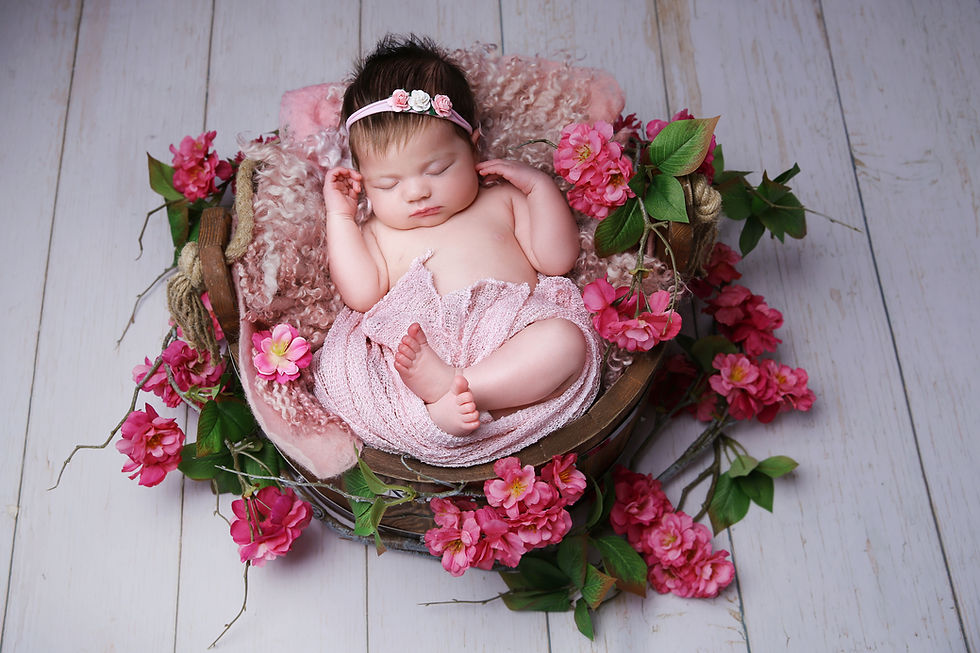 Close-up view of a baby’s tiny hand holding a soft blanket