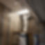 Worker in suit removing ceiling tile on scaffold
