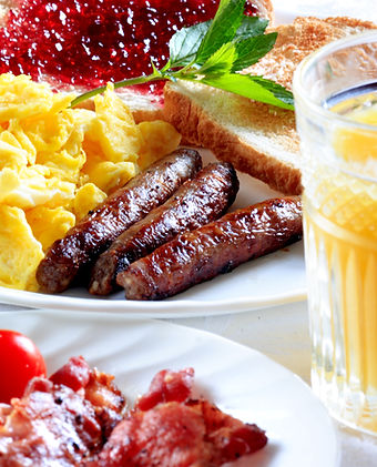 Plated breakfast with eggs, bacon, and toast