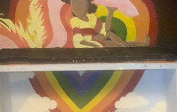 Heart shaped rainbow around girl sitting with dragon