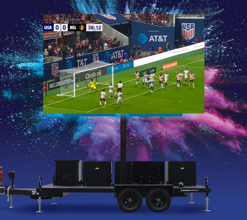 Eye-level view of a large LED video wall displaying vibrant visuals at an outdoor concert