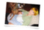 A mom with her baby and dog on a nursing pillow
