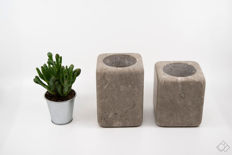 handmade stone planter in two variations of color - dark grey limestone with fossils and light gray limestone, and 3 size variations
