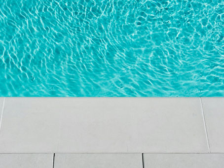 clear blue pool water and white tiles